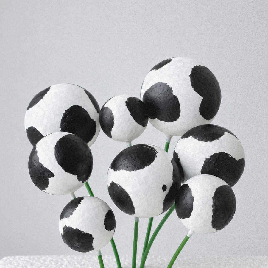 cake ball decorations in black and white cow print
